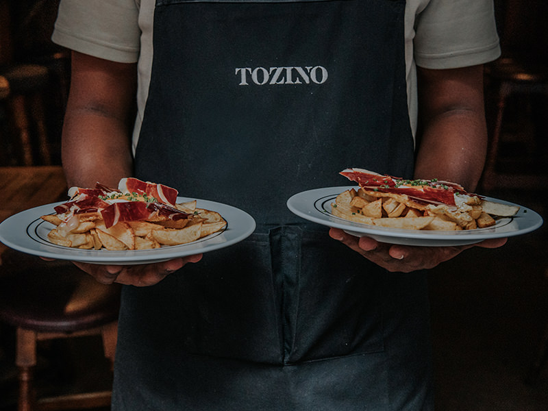 Sliced Ibérico ham served with fries and a fried egg